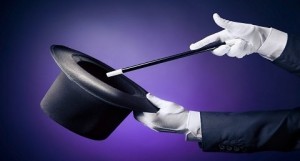 A photo of a magician's gloved hands holding a top hat and a wand