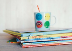 A pile of story books with a mug on top of them