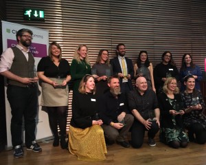 A photo of all the winners in a group holding their awards