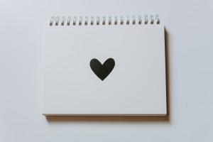 A notebook with a love heart on the front